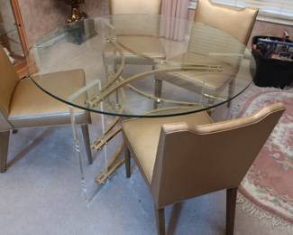 50"  glass  top  table  with lucite bases.          Hollis  Jones  mid  century  table.   It  has  4  chairs.