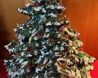 Vintage ceramic light up Christmas tree, snow flocked with multi-colored bulbs.