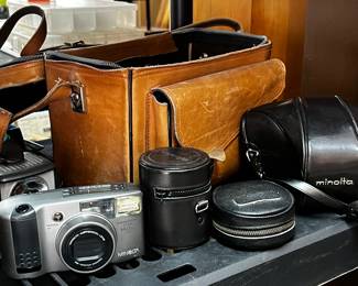 Minolta with lens and case and other cameras