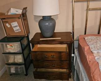 Downstairs bedroom. 1 of 2 side tables. 1 of 2 blue lamps