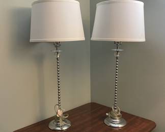 Matching chrome table lamps with beaded stems and white drum shades. Clean modern style, see minor dent in photo. Approx. ~27" tall. 