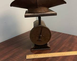 Early 1900s metal counter scale marked "2100-2104 S. Broadway." Measures approx. 13" tall, aged patina throughout.