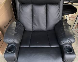 Black faux leather power lift recliner featuring dual cup holders, wide padded armrests, and plush back support. Electric lift and recline functions provide effortless comfort and accessibility. Tested and in good working condition with minor wear consistent with use.