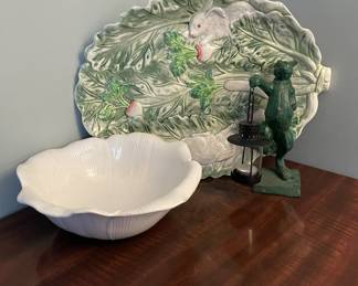 Lovely decorative grouping featuring a Stafford-style platter with raised rabbit and leafy detail, a cabbage-inspired ceramic bowl, and a cast metal rabbit figure holding a lantern. 
