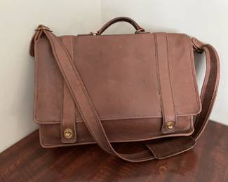 Classic Coach messenger bag crafted from genuine glove-tanned leather in a rich brown tone. Features brass hardware, adjustable shoulder strap, top handle, and flap closure. Stamped with serial number No. 0578-333 inside. A timeless, durable design from Coach's vintage collection. See photos for condition. 