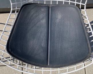 Bertoia Indoor-Outdoor Side Chair, manufactured by Knoll. We have 6 of these to sell that have been outside.  DWR retail price: $930.00. 
Configuration: Side Chair
Style: With seat Pad
Frame: White
Base Finish: White
Upholstery: Vinyl - Color Black