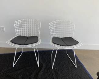 Bertoia Indoor-Outdoor Side Chair, manufactured by Knoll. We have 2 of these to sell.  DWR retail price: $930.00. 
Configuration: Side Chair
Style: With seat Pad
Frame: White
Base Finish: White
Upholstery: Vinyl - Color Black