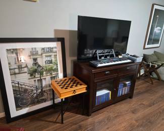TV entertainment cabinet, TV, small keyboard, Checker/Backgammon game table, wall art and throw pillows
