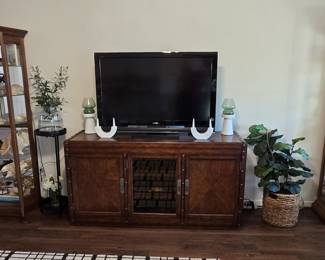 TV, entertainment cabinet flanked by curio cabinets