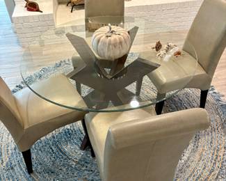 Faux Leather Chairs with Glass  Dining Table and pretty pastel rug.