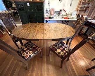Table with six chairs and one leaf.                                                    60" L x 40" W x 29 3/4" H.
