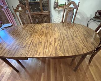 Table with six chairs and one leaf.                                                    60" L x 40" W x 29 3/4" H.