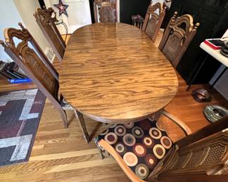 Table with six chairs and one leaf.                                                    60" L x 40" W x 29 3/4" H.