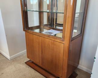 French Art Deco Vitrine/ Display Cabinet w/ Original Pedestal Laquered Satin wood, Beveled Glass & Mirrored Interior measures 3'1"(W) x 16"(D) x 4' 7"(H). This is a Collected Object. Not a reproduction .