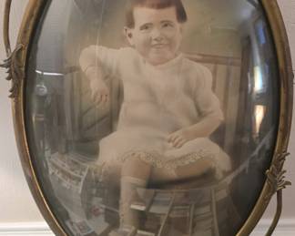 Vintage bubble glass picture frame With the absolute CREEPIEST child with a Old man's head Ive ever seen lol its way better in person 