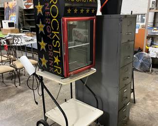 Two separate pieces. Cart and Rockstar energy drink fridge. Fridge runs but does not get cold. It hasn't been used in many years. Has not been checked by anyone.