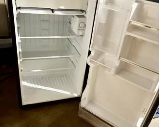 Small stand-up fridge perfect for an apartment or dorm.