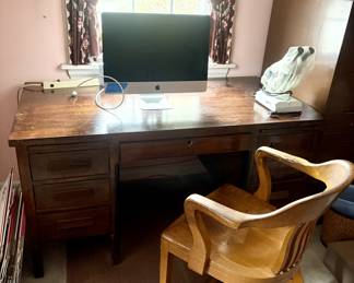 Solid wood desk, wood office chair and a Mac computer.