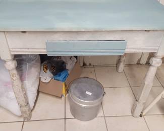 Camping kit underneath a vintage kitchen table