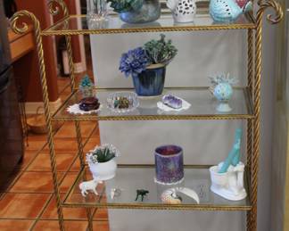 gold metal and glass display shelves