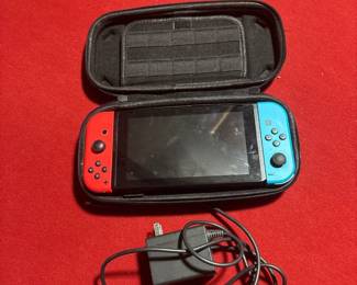 Nintendo switch with Blue and Red bitcoins plus cord and carrying case. Tested and working