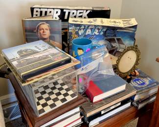 Star Trek items = coffee mug, books, dvds, game and a Star Wars game and album.