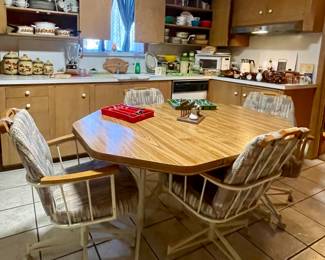 VINTAGE DINING TABLE WITH 4 ROLLING CHAIRS-HAS A LEAF IN, CAN BE MADE SMALLER