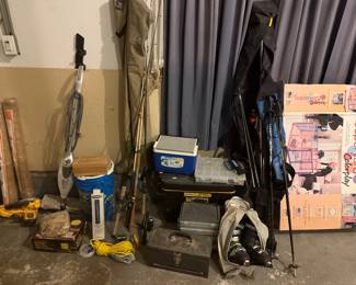 Various outdoor items, including skis, fishing poles and waders.