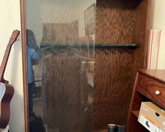 Gun cabinet with glass doors and drawers below