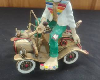 vintage sculpture of a clown in a car by the artist Ron Lee