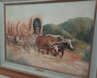 covered wagon being pulled by two oxen