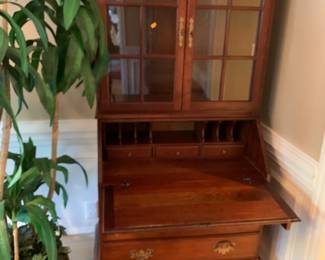 #115	2 piece Secretary Wood Secretary w/drop-down Front & Cubbies w/2 Glass doors & 3 Drawers w/pull-out desk w/2 wood shelves- 30x17-27x72	 $175.00 			
