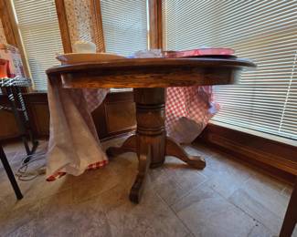 Oak pedestal table with 6 oak press back chairs