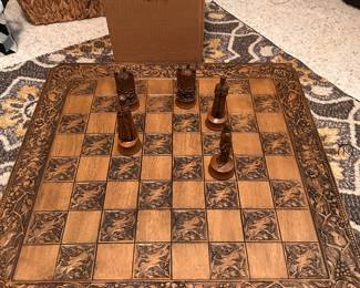 large tabletop chess board with carved pieces