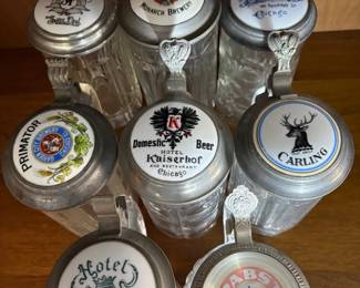 Collection of Glass Beer Steins with Hinged Lids and Thumb Lever
