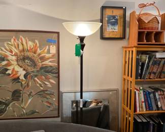 Chalk pastel, orange and green sunflower with tan background | silver framed mirror | tall black standing lamp with curved glass dome. | Antique books