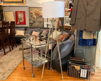 Stainless steel, wheeled bar cart with mirrored and see through glass. Brass, 3 legged lamp, with cream shade.