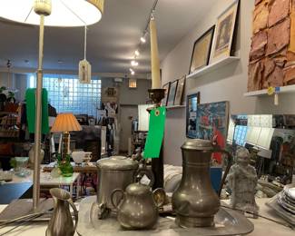 Assorted pewter wares, such as a candle stick, sugar bowl, cream holder, vase, and pitcher