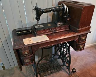 Antique New Home sewing machine and cabinet
And an antique Singer sewing machine AB412266