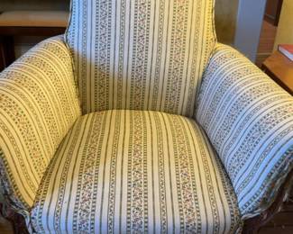 Wingback Armchair With a Floral and Striped Pattern Upholstery.