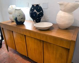 Mid-century modern sideboard with pottery pieces by homeowner