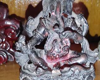 Ganesha figurine is easily identifiable by his elephant head and is revered as the Lord of Success and the Remover of Obstacles. 
He is also worshipped as the god of knowledge, wisdom, wealth, and the fine arts. 