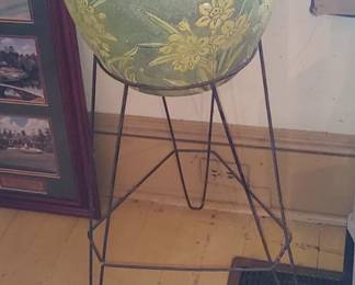 Large planter with yellow daffodils and metal holder