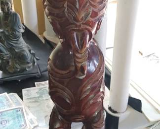 Maori Teko Teko wood carving 

Teko Teko figures are significant in Maori culture, symbolizing guardianship and protection for the tribe. 
The figures typically feature intricate carvings, including facial tattoo designs (moko), and often have inlaid eyes made from paua shells. 
The extended tongue, a common feature in these carvings, can represent a challenge or a sign of an accomplished warrior. 