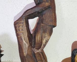 Which folk art carved man in hat
