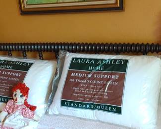 Antique spindle bed near Laura Ashley pillows and authentic Raggedy Ann doll