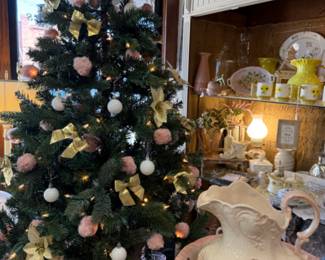 Beautiful Christmas tree decorated in pink, gold and white, antique was basin and pitcher