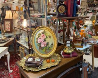 antique wooden fireplace screen, floral book ends, oval framed floral, brass serving tray