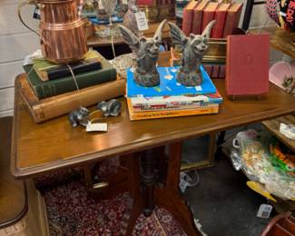 Vinage table - beautiful carved base, copper tea pot, cement gargoyles, vinage books, book decor, copper and brass hanging butterfly decor