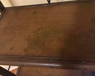 2 matching metal designer shelves with map motifs on the shelves 